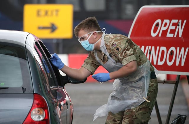 A soldier from 2nd Scots Royal Regiment of Scotland takes a test sample at a Covid-19 testing centre at Glasgow Airport (Photo: Andrew Milligan-WPA Pool/Getty Images)
