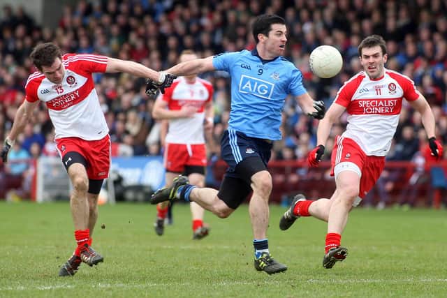 Dublin's Michael Dara Macauley takes on Benny Heron and Mark Lynch during Derry's 2014 Division One victory in Celtic Park. (Photo Lorcan Doherty / Presseye.com)
