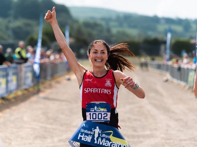 Female winner Catherine Whoriskey crosses the finishing line at the Melvin Sports Centre on Sunday. (Photo: Karol McGonigle)