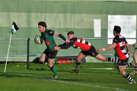 City of Derry’s Killene Thornton evades a tackle from Andrew McMurray to score a try against Cooke. Photo: George Sweeney