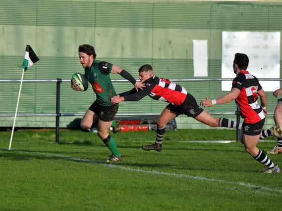 City of Derry’s Killene Thornton evades a tackle from Andrew McMurray to score a try against Cooke. Photo: George Sweeney