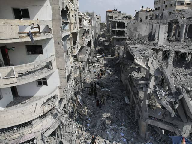 Palestinians look for survivors after the Israeli bombardment of the Gaza Strip in Deir Al-Balah. Picture: AP Photo/Hatem Moussa