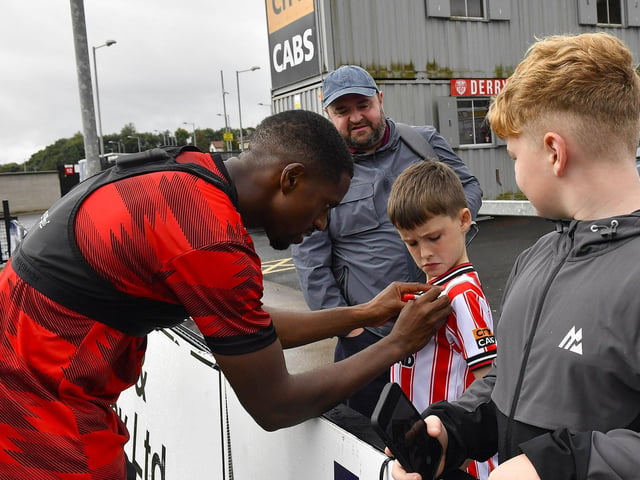 Sadou Diallo signs a shirt for a fan at the Derry City open training session on Monday morning in Brandywell Stadium. The event was organised at part of the Gasyard Feile. Photo: George Sweeney / Derry Journal