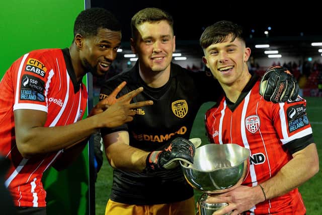 Derry City players Sadou Diallo, Brian Maher and Adam O’Reilly with the President’s Cup after their victory over Shamrock Rovers at the Brandywell on Friday evening. Photo: George Sweeney. DER2307GS – 87