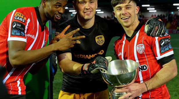 Derry City players Sadou Diallo, Brian Maher and Adam O’Reilly with the President’s Cup after their victory over Shamrock Rovers at the Brandywell on Friday evening. Photo: George Sweeney. DER2307GS – 87