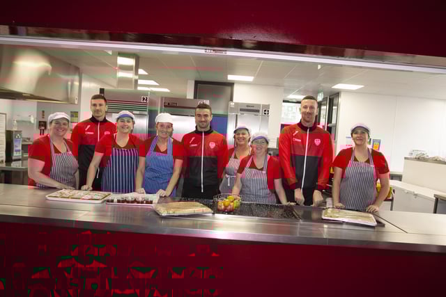 Derry City payers Shane and Patrick McEleney and Michael Duffy with canteen staff at Steelstown Primary School during a visit to the school ahead of Sunday's FAI Cup final. (Photo: Jim McCafferty)