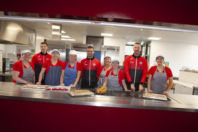 Derry City payers Shane and Patrick McEleney and Michael Duffy with canteen staff at Steelstown Primary School during a visit to the school ahead of Sunday's FAI Cup final. (Photo: Jim McCafferty)