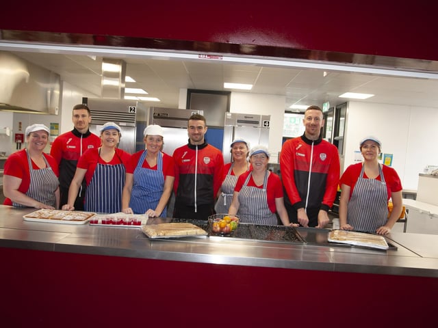 Derry City payers Shane and Patrick McEleney and Michael Duffy with canteen staff at Steelstown Primary School during a visit to the school ahead of Sunday's FAI Cup final. (Photo: Jim McCafferty)