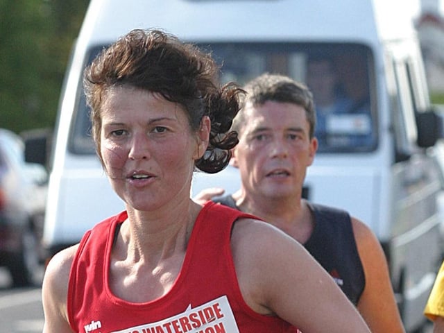 Runner Linda Hall keeps in front of a group of runners in the early stage of the race. (1609T49).:.