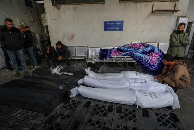 RAFAH, GAZA - JANUARY 24: (EDITOR'S NOTE: Image depicts death) People mourn as they collect the bodies of friends and relatives killed in an airstrike on January 24, 2024 in Rafah, Gaza. The toll since the Oct. 7 war in Gaza between Israel and Hamas now exceeds 25,000 dead and 62,000 injured, according to the territory's health ministry. Two-thirds of the victims are believed to be women and children. The United Nations estimates for its part that more than 18,000 Palestinian children have lost a parent. With 25 per cent of the population, or more than half a million people, are in a situation of "food catastrophe" and threatened with famine.(Photo by Ahmad Hasaballah/Getty Images)