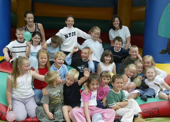 Children from the Tullyally area pictured with Playgroup asistant Elaine Campbell and Playgroup co-ordinator Leanne Street at the end of the Club United summer scheme. (2908JB13):Derry youngsters enjoying summer in August 2003