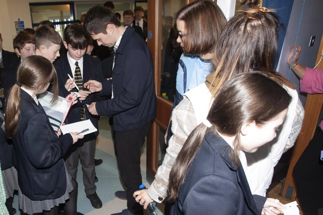 Damian signing autographs for students at Lumen Christi College on Tuesday.