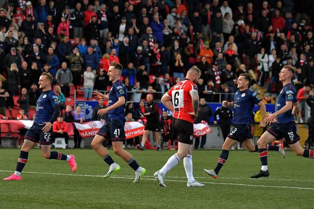 St Patrick’s Athletic players rush past a dejected Mark Connolly after his penalty miss in the FAI Cup game at the Brandywell on Sunday evening. Photo: George Sweeney. DER2334GS – 08