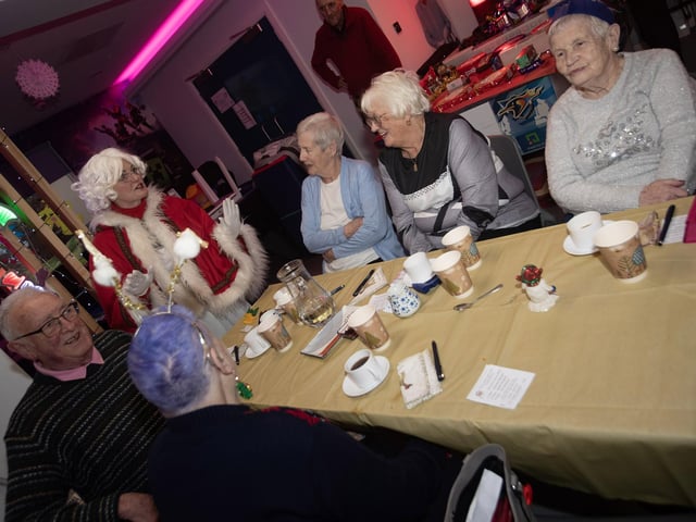 Mrs. Claus entertaining some of the group at last week's Senior Citizens Christmas Party in the Cathedral Youth Club.