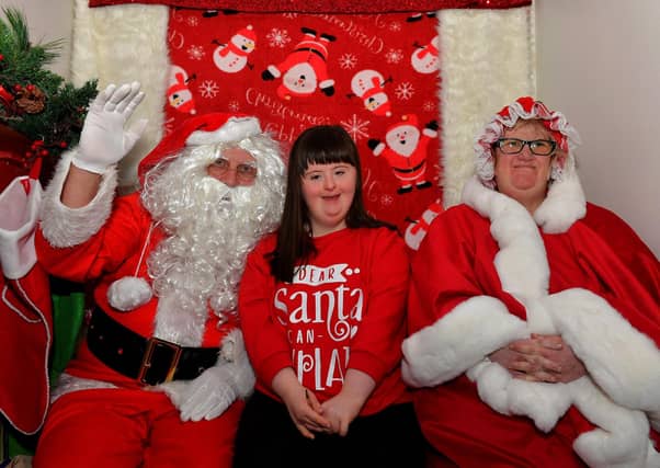 Niamh pictured with Santa and one of his helpers at the Christmas Wonderland at Destined, organised by the Western Trust Children’s Disability Team and the Destined Team. Photo: George Sweeney