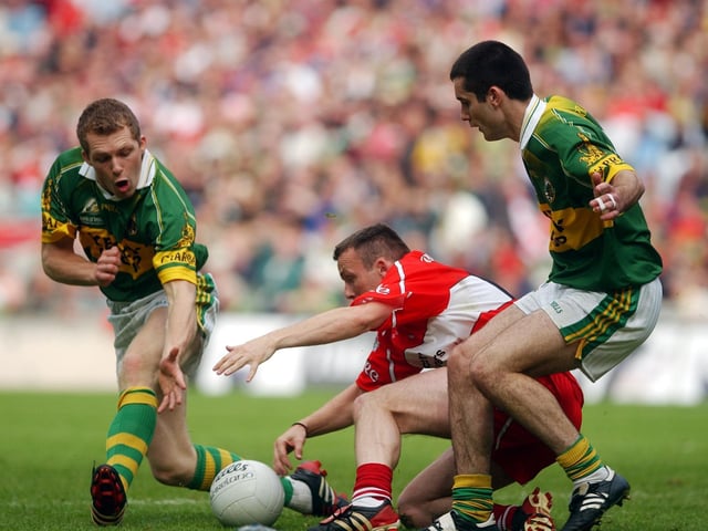 Derry forward Paddy Bradley finds himself outnumbered by Kerry defenders in Croke Park.
