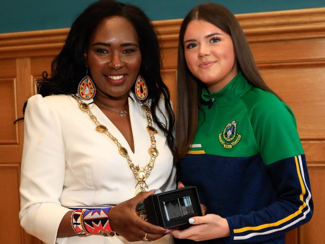 Mayor Lilian Seenoi Barr makes a presentation to Chantelle O'Neill at a reception for Craigbane GAC and Clann na nGael GAC held in the Guildhall. (Photo - Tom Heaney, nwpresspics)