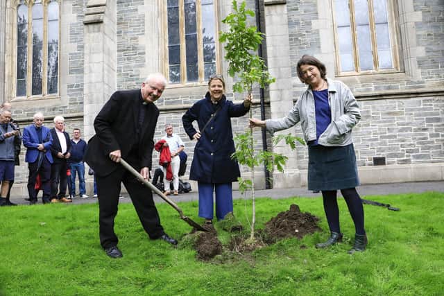 Pat’s daughters Áine and Thérèse with Bishop Dónal McKeown at the tree-planting.