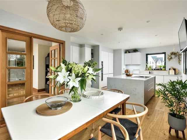 The dining kitchen has contemporary fittings, quartz worktops, and appliances including an American style fridge freezer, wine cooler, dishwasher, microwave/oven, and induction hob with downdraft extractor.