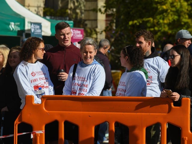 Fundraising teams members who took part in the pulling of a 32-tonne City of Derry Airport Fire and Rescue Engine, in Guildhall Square, in aid of Children In Crossfire. Photo: George Sweeney