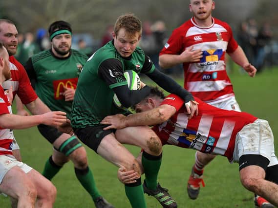 David Lapsley of City of Derry bursts through the Randlestown cover to score a first half try. Photo: George Sweeney