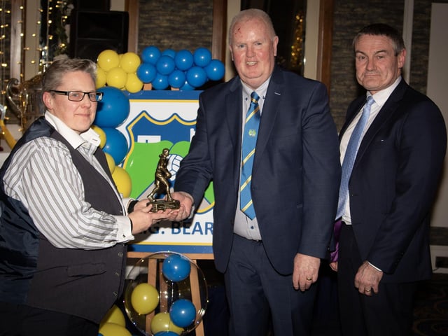 Tara Reddin, Gaelic for Mothers & Others Player's Player of the Year 2024, receives her trophy from Liam Gallagher, Club Chair. On right is Mr. Ciaran McLaughlin, former Ulster President, GAA. (Photos: Jim McCafferty Photography)