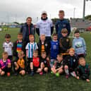 Children pictured at the launch of the Ryan McBride 2023 Summer Camp, at the Brandywell Stadium, with Portsmouth winger Ronan Curtis, who officially launched the summer camp , and coaches from the Foundation. Photo: George Sweeney. DER2327GS - 003