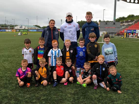 Children pictured at the launch of the Ryan McBride 2023 Summer Camp, at the Brandywell Stadium, with Portsmouth winger Ronan Curtis, who officially launched the summer camp , and coaches from the Foundation. Photo: George Sweeney. DER2327GS - 003