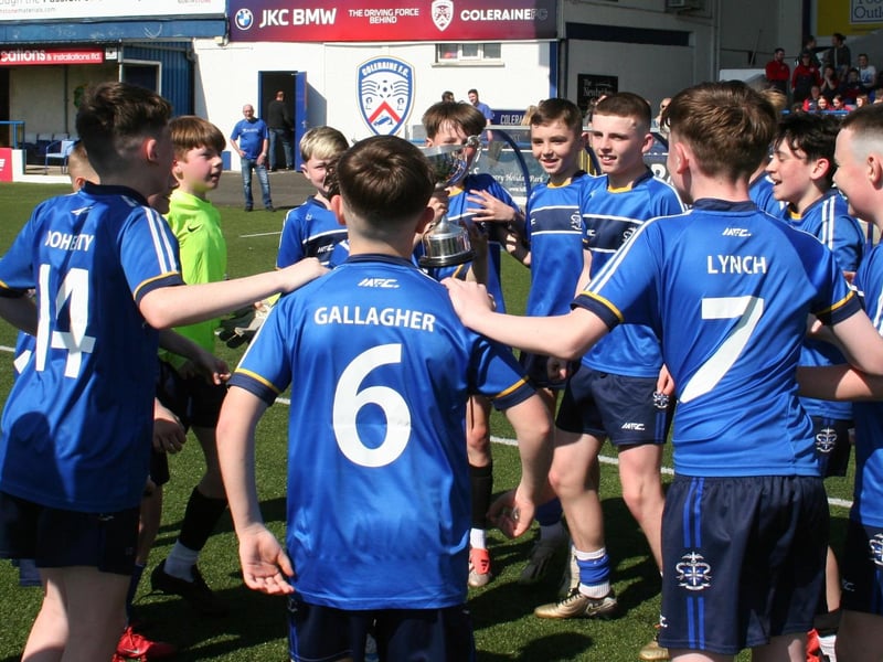 St Columb's College's young guns celebrate with the trophy.