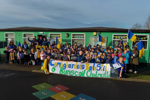 Staff and pupils from Bunscoil Cholmcille Steelstown welcome Derry, Ulster and All Ireland Intermediate club football champions to the school on Friday morning last. Photo: George Sweeney.  DER2206GS – 103