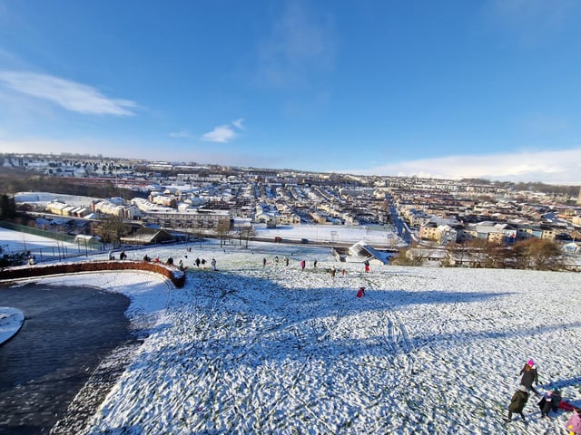 People sleighing on the slopes below Double Bastion.