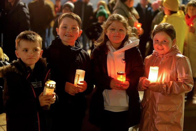 Children carry lighted candles at a vigil, held in Guildhall Square on Monday evening, to remember those who died in the Creeslough tragedy on Friday afternoon last.  Photo: George Sweeney.  DER2241GS – 47
