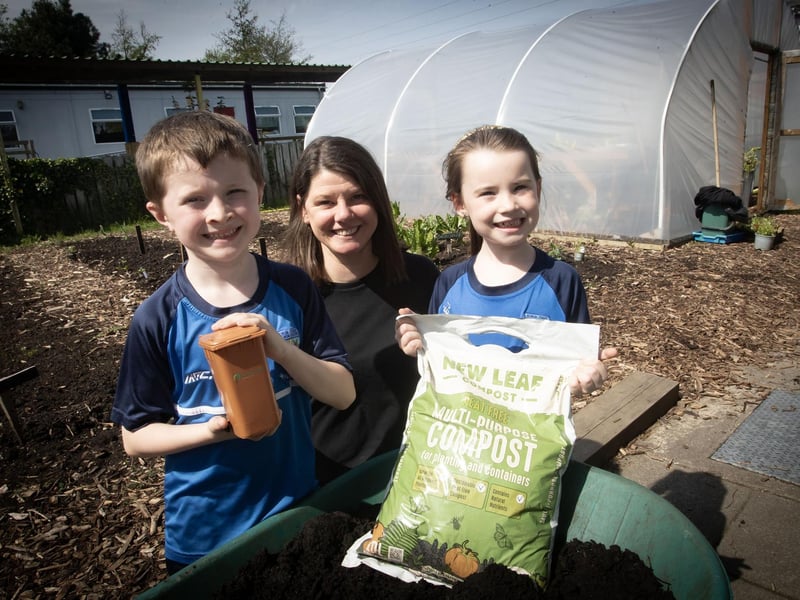 Sharon with two of the young pupils during Tuesday's 'No Dig' garden experience at Hollybush PS.