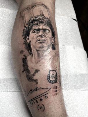 Age 21 from Grangemore. Ethan has been tattooing now for just over a year. "I decided to go with this piece as I think it shows best the style of work I most prefer to do.  It’s always a test tattooing portraits but when it’s of one of the greatest footballers of all time Maradona, I couldn’t say no.I have always had a love for design but this grew some years ago when I began to create digital illustrations and animations. As I got more experience I became increasingly interested in the art of tattooing specifically. I was drawn to the creativity involved in designing unique tattoos for people, and has allowed me to use my art to help people decorate their bodies with meaningful designs that become part of their life."