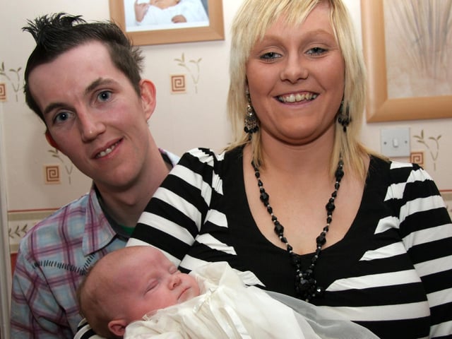 Proud parents Victoria and Mark pictured with Megan on the occasion of her Christening 0045JML : Parties and celebrations March 2006: Megan Ann Eileen Smith.