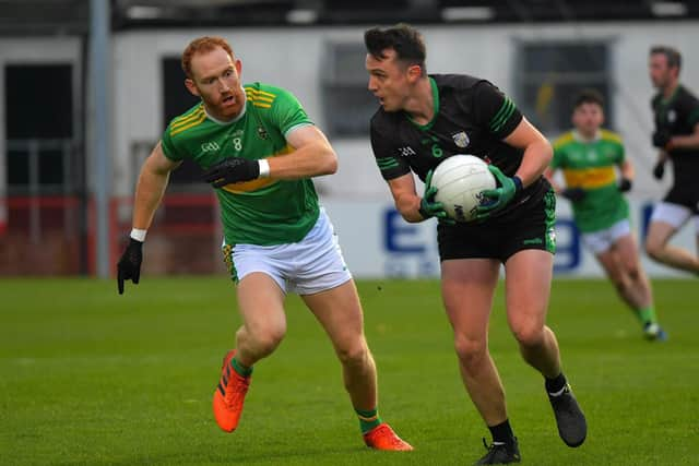 Glen’s Conor Glass closes in on Paul McCann of Cargin. Photo: George Sweeney