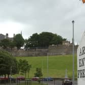 Free Derry Corner with the Derry Walls in the background.