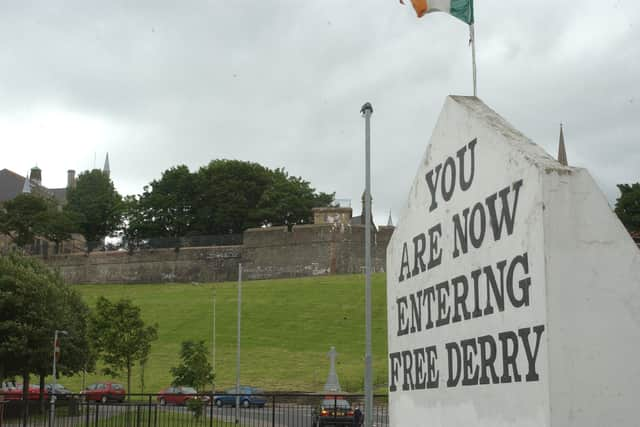 Free Derry Corner with the Derry Walls in the background.