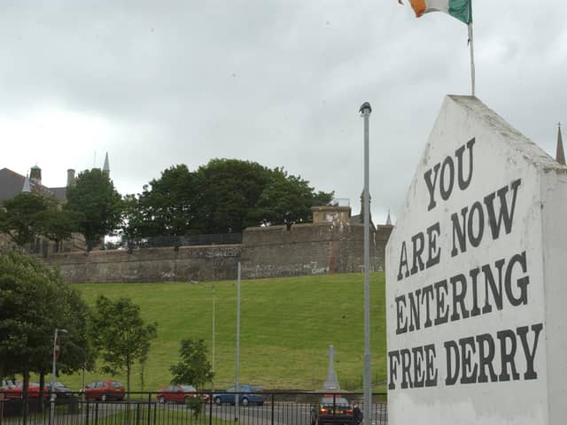 Free Derry Corner with the Derry Walls in the background.