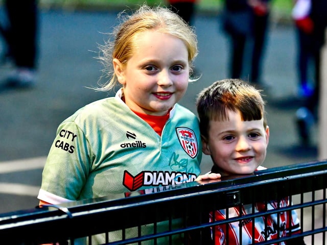 Young Derry City supporters pictured pitchside on Friday night.