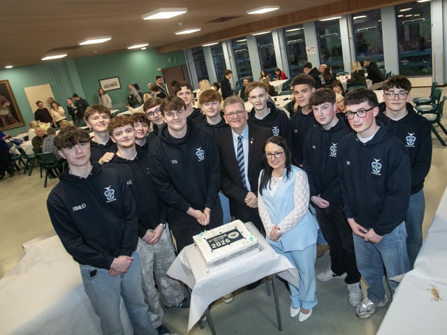 Mrs. Caroline McLaughlin, Principal and Mr. Donal Chambers, retiring Head of Year pictured with Year 14 students preparing to cut the 'Class of 2026' cake on Thursday last. (Photos Jim McCafferty Photography) : .