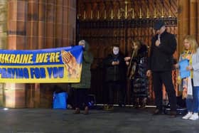 Organisers of the candle-lit vigil in solidarity with the people of Ukraine with Fr Ignaacy Saniuta at Guildhall Square in March. Photo: George Sweeney. DER2209GS – 030