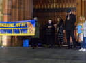 Organisers of the candle-lit vigil in solidarity with the people of Ukraine with Fr Ignaacy Saniuta at Guildhall Square in March. Photo: George Sweeney. DER2209GS – 030