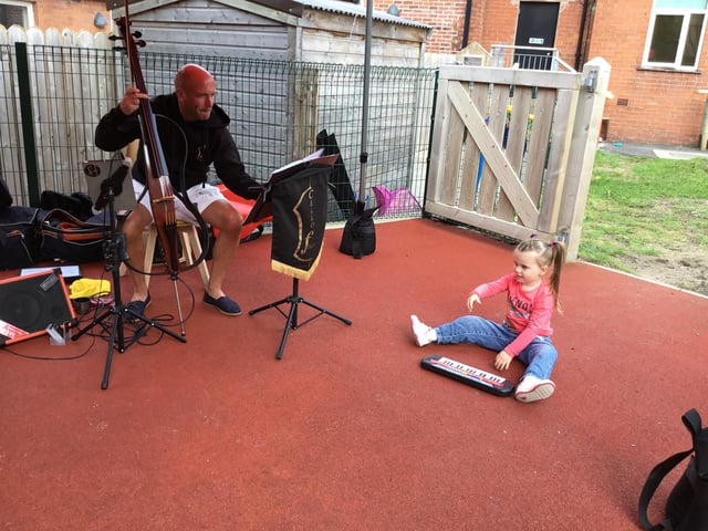 The Cello Fella with a young musician at Top of the Tots