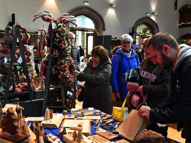 People browse the large range of gifts at the Guildhall Christmas Fair on Monday afternoon .Photo: George Sweeney / Derry Journal