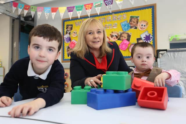 Education Minister Michelle McIlveen with P1 pupils Daniel and Declan during a tour of the new school. ©Lorcan Doherty