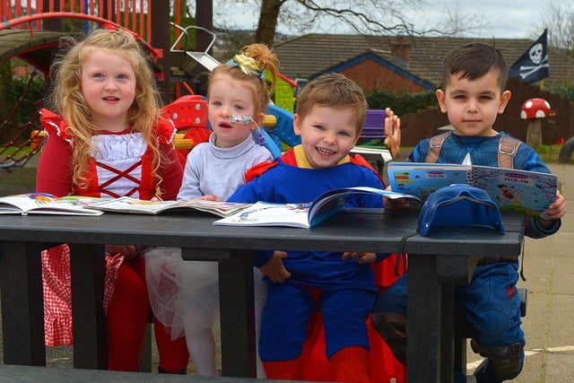 Willow, Lena, Jonah and Aylan enjoy reading their favourite books, on World Book day, at Belmont Nursery School on Racecourse Road. Photo: George Sweeney. DER2310GS – 29