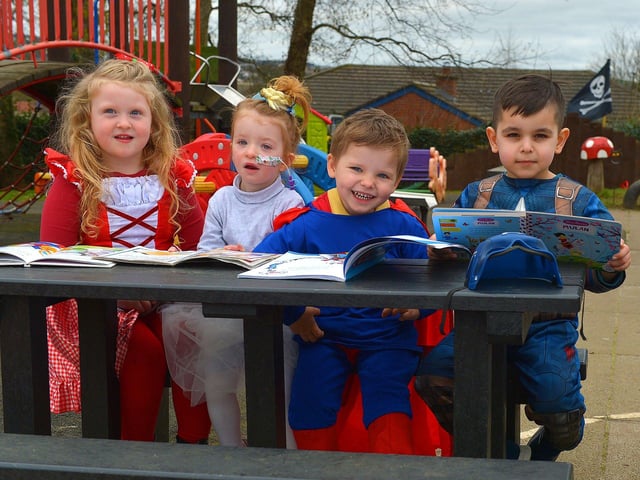 Willow, Lena, Jonah and Aylan enjoy reading their favourite books, on World Book day, at Belmont Nursery School on Racecourse Road. Photo: George Sweeney. DER2310GS – 29