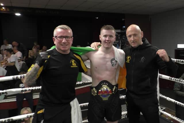 Conal McBrearty pictured with Rath Mor Warriors coaches Mark Clifford and Sean McGill after the Creggan man won the ISKA British welterweight title in England.