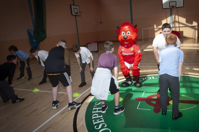 Fred the Red, the Manchester United Foundatioin mascot joins in some of the games during Induction Day at St. Joseph’s Boys School on Tuesday.